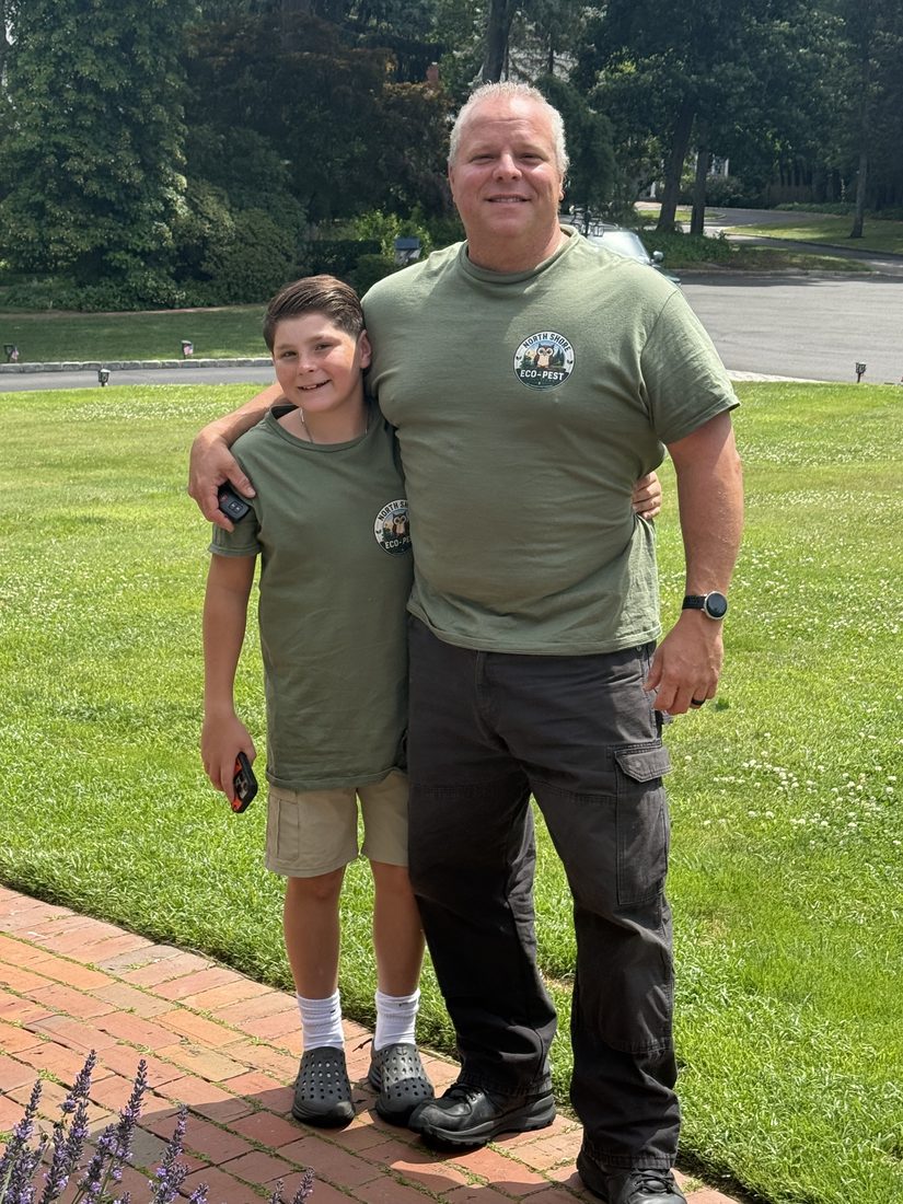 Steve Rocco Tardalo and his son in North Shore Eco-Pest shirts at a customer's property